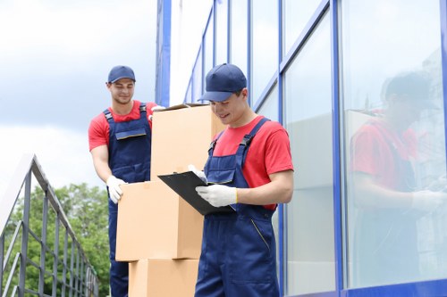 Team loading a van safely with protective moving equipment
