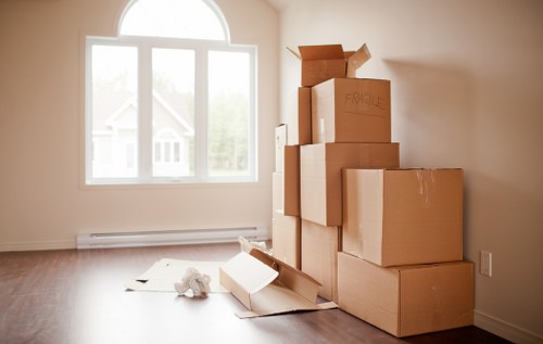 Movers carrying items through a shared staircase in a Kingston apartment block